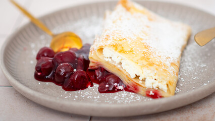 Pancakes, thin pancakes on a plate with cherries and cheese.
