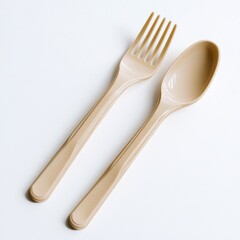 A minimalist view of a beige plastic fork and spoon on a white background, highlighting simplicity.