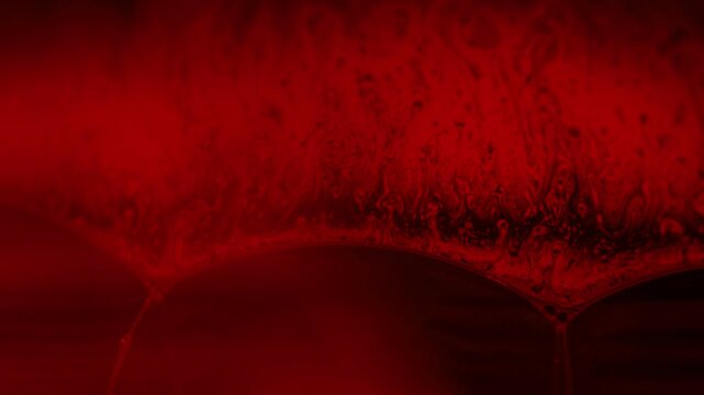 Red reflections of liquid in macro, red liquid surface, bubbles in macro, black and red horror background, creepy scientific abstract 