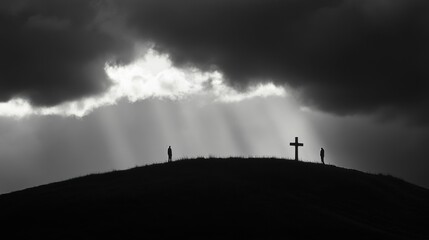 Obraz premium Hill with Cross, Silhouetted Figures, and Light Rays in Monochrome