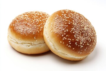 Two soft and fluffy sesame buns with sesame seeds on a white background, perfect for baking or photography