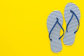 Striped blue flip-flops on color background, top view