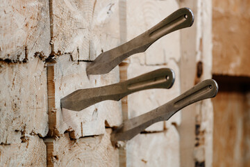 three metal knives in wooden block stand as target, throwing knives, sports competition, selective focus