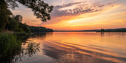 Obraz premium Sunset Over a Calm Summer Lake