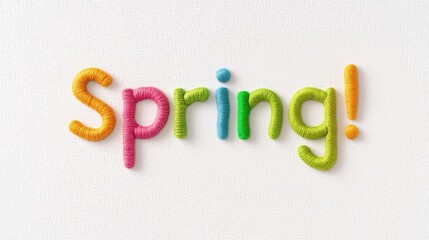 The word Spring! is spelled out using colorful yarn wrapped around letters, conveying a playful and joyful spring theme. The bright hues of the letters stand out against a clean white background.