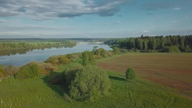 A beautiful cinematic frame of nature. A picture of a small river among fields