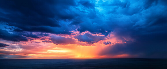 Vibrant sunset over the ocean with dramatic sky, illuminated by rays of sunlight breaking through the clouds, showcasing nature's beauty and calmness at dusk.