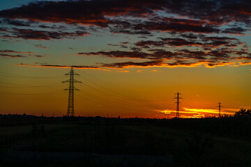 Detail of electric pole with electric cables and crop fields