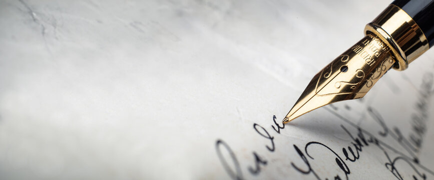 Fountain pen on an antique handwritten letter. Vintage nib pen and handwritten cursive style font copperplate, spencerian. Old history background. Retro style.