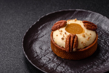 Sweet round tart with white citrus cream and pecans