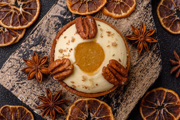 Sweet round tart with white citrus cream and pecans