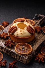 Fototapeta premium Sweet round tart with white citrus cream and pecans