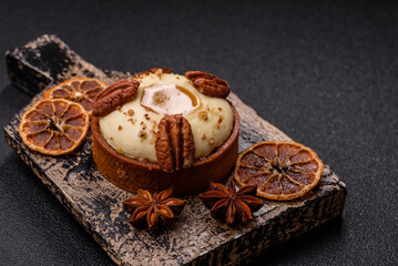 Sweet round tart with white citrus cream and pecans