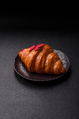 Sweet crispy croissant decorated with red hearts