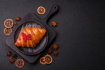 Sweet crispy croissant decorated with red hearts