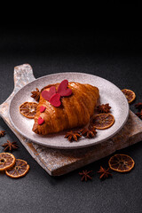 Sweet crispy croissant decorated with red hearts