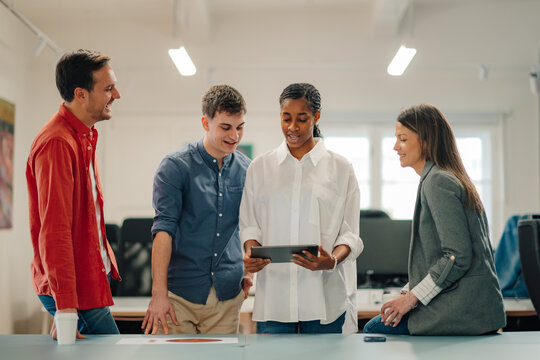 Business people collaborating using digital tablet in office meeting