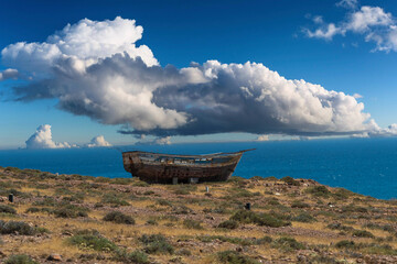 photographs of fishing boats barred in the sand on the beach