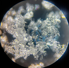 View on snowflake under microscope ocular