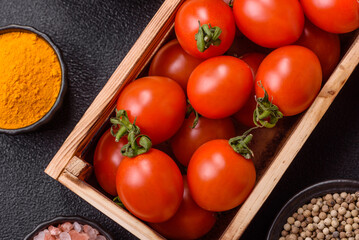 Ripe red cherry tomatoes in a wooden box