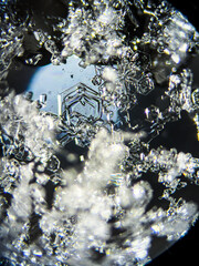 View on snowflake under microscope ocular