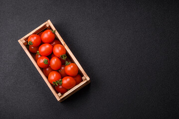 Ripe red cherry tomatoes in a wooden box