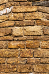 Rustic stone wall with irregular brown rocks and white mortar, creating a textured architectural background.