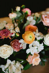 Beautiful mixed flower arrangement featuring ranunculus and lilies in a warm setting