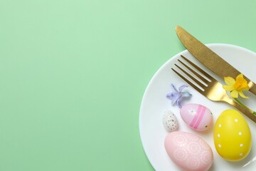 Happy Easter. Top photo with plate, cutlery, eggs on color background with empty space