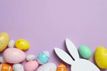 Happy Easter. Colorful eggs and white bunny ears on color background, space for text or advertising