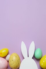 Happy Easter. Colorful eggs and white bunny ears on color background, space for text or advertising