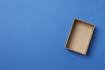Open cardboard box on blue background