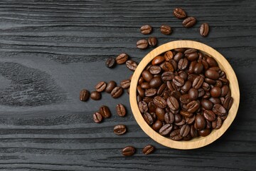 Fresh coffee beans in a bowl on wooden background