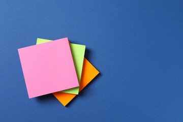 Multicolored paper stickers on a blue background