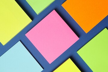 Multicolored paper stickers on a blue background
