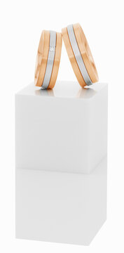 Wedding rings on top of white pedestal.