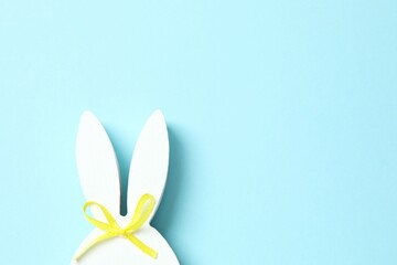 Happy Easter. White bunny ears on blue background, space for text or advertising