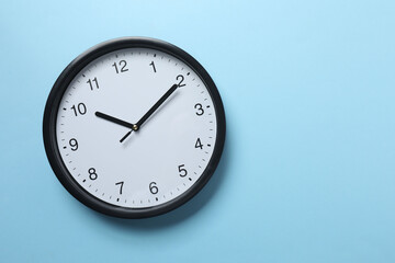 Big beautiful stylish clock on blue background