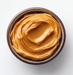 Fototapeta premium Smooth and creamy texture of organic peanut butter swirled in a rustic bowl, ideal for culinary and dietary themes