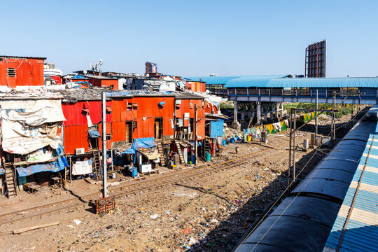 Shanty dwellings next to railway tracks in Dharavi slums at Bandra Railway station in Mumbai, India. Asia