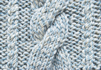 Soft light blue wool crossed cable ornament texture as background