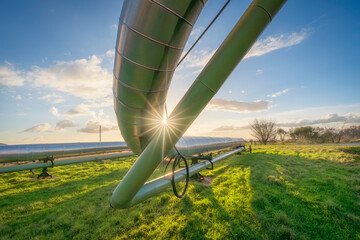 Geothermal energy. Pipelines of a plant at sunset in Larderello, Tuscany region, Italy
