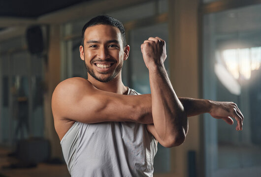 Smile, man and stretching with portrait at gym as bodybuilder, strong muscle and exercise. Athlete, male person and prepare with fitness warm up, sports training and workout challenge of bodybuilding