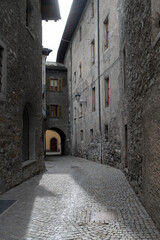 Narrow cobblestone street in the historic town of Bormio, Italy.