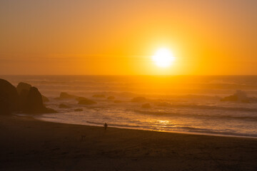 An orange sunset on the ocean in Northern California.