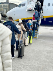 Crowd of People With Suitcases Wearing Winter Clothes at Airport Boarding Before Departure