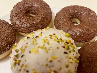 chocolate donuts on white plate
