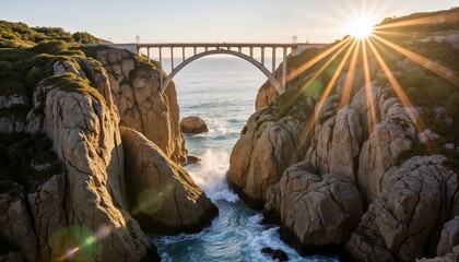 Obraz premium Majestic bridge spanning over a deep canyon with ocean view and sunset light creating dramatic landscape.