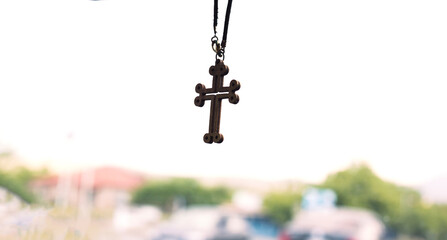cross icon hanging on car rear-view mirror