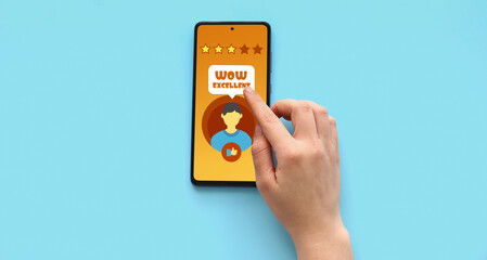 Female hand with modern mobile phone on blue background, closeup